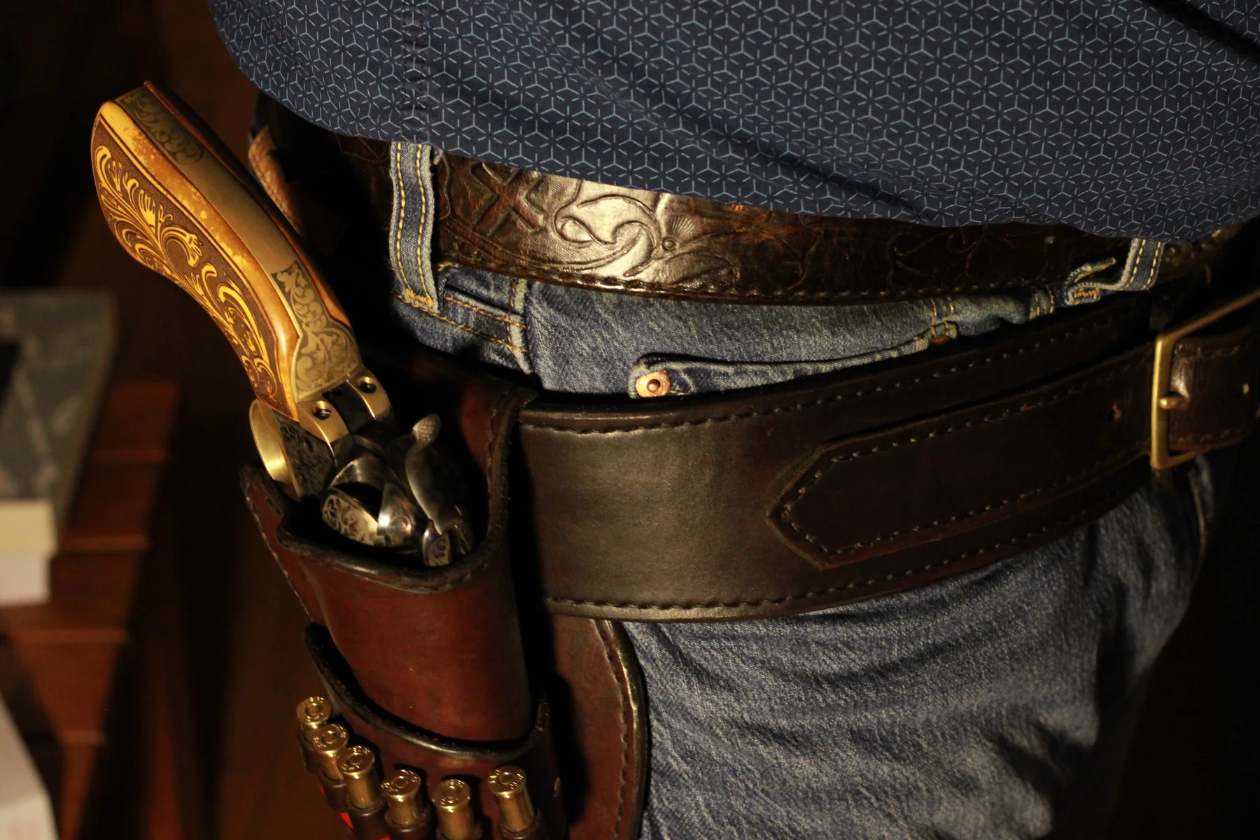 Western leather holster worn with a revolver