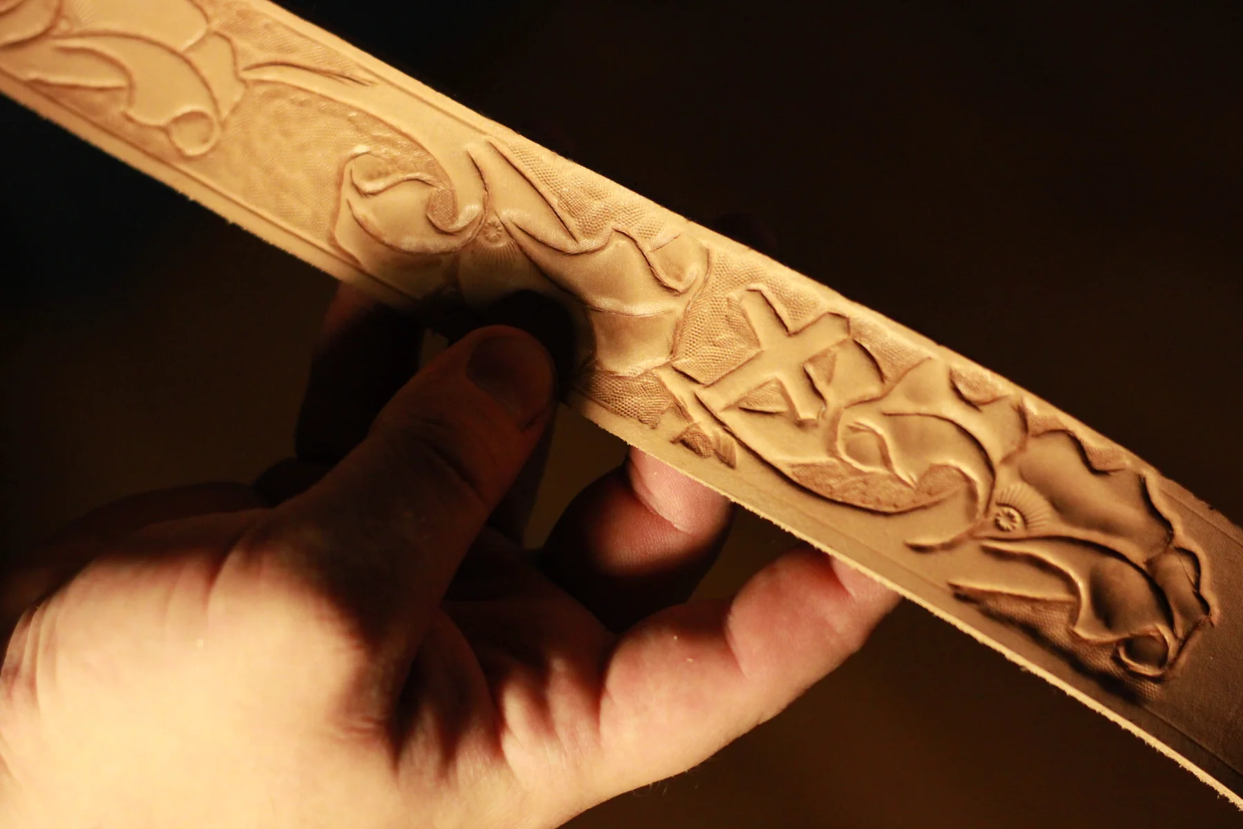 Detailed hand-carved floral leather tooling